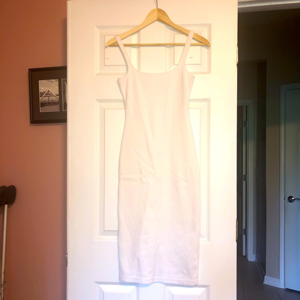 Sexy, curve hugging dress with back slit